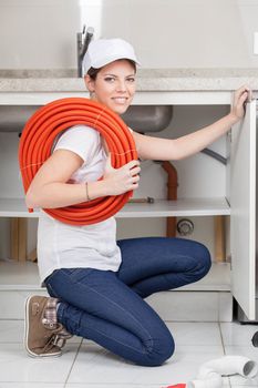 Woman plumbing with corrugated pipe