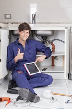 Plumber man with his finger up holding his tablet