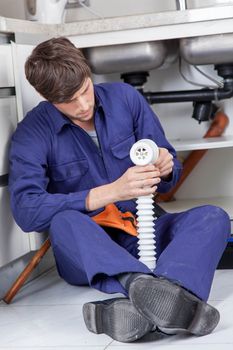 Plumber holding a pipe