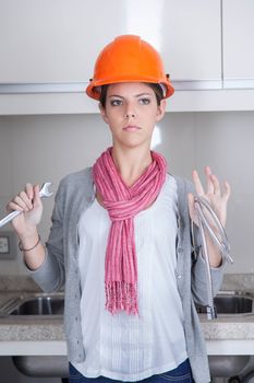 Woman plumbing with tools