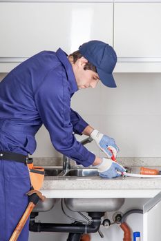 Plumber by unscrewing the sink