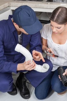 Couple plumbers discussing work