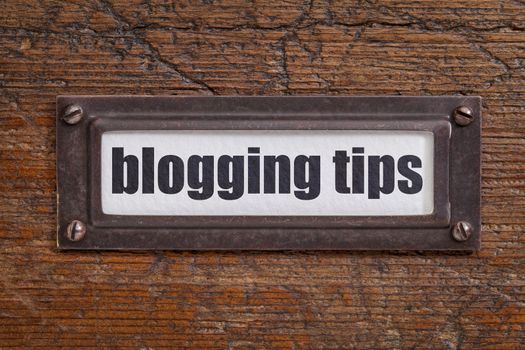 blogging tips  - file cabinet label, bronze holder against grunge and scratched wood