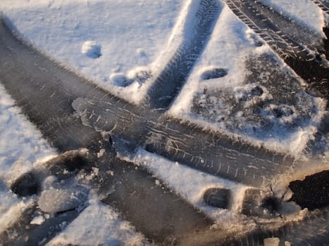 Close details of car tire track in the snow