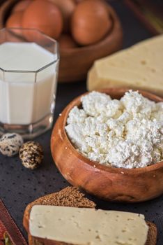 still life with dairy products as milk, cheese cottage cheese eggs and bread 
