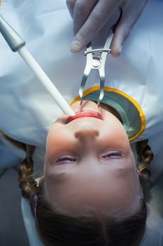Close up of girl having her teeth examined by a dentist