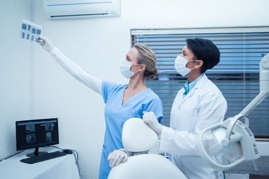 Concentrated two dentists looking at x-ray