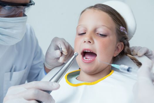 Close up of girl having her teeth examined by a dentist