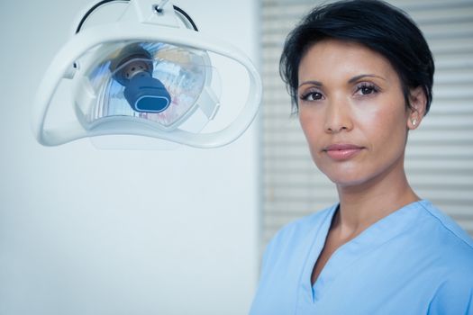 Portrait of serious young female dentist