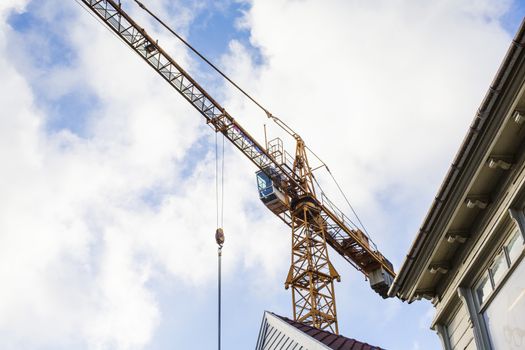 A Tower Crane Overlooking Urban Redevelopment Old Town Stavanger Norway against a Cloudy Sky