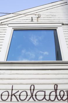 Window Refecting The Blue Sky Set Into a Wooden Building in old Town Stavenger Norway