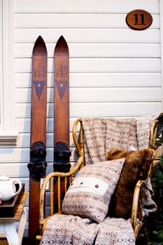 Traditional Wooden Norwegian Ski Against A white Wooden Building Still Life