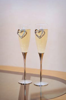 two glasses with champagne standing on the table