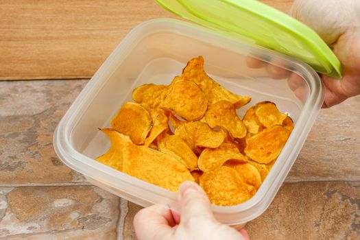 Sweet potato chips stored in an air tight container.