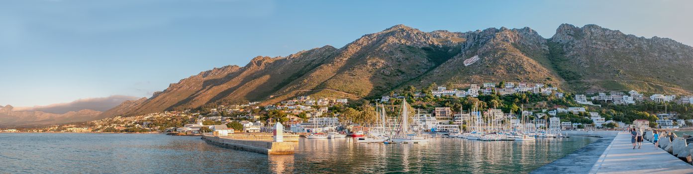 CAPE TOWN, SOUTH AFRICA - DECEMBER 11, 2014:  Sunset panorama of the harbor in Gordons Bay with the Hottentots-Holland Mountains and the Sir Lowrys Pass in the back