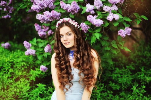 beautiful young girl on a background of flowering trees