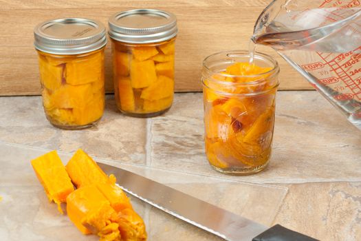 Canning sweat potatoes for storage.