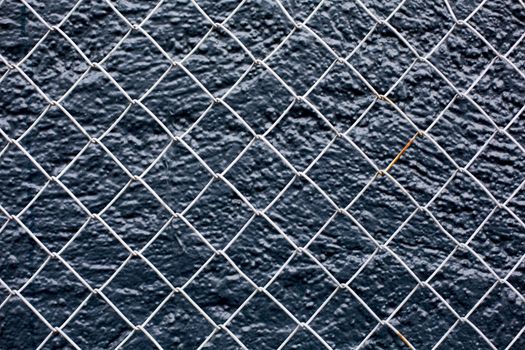 Wire Fence Tight Against A Black Background