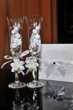 two glasses with champagne standing on the table.