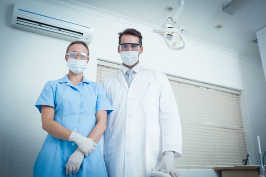 Portrait of male and female dentists wearing surgical masks