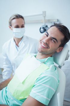 Portrait of smiling young man waiting for a dental exam