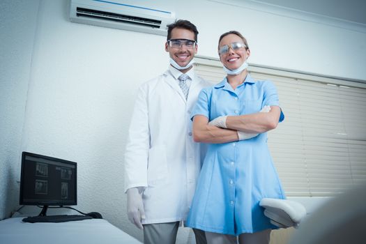 Portrait of smiling male and female dentists