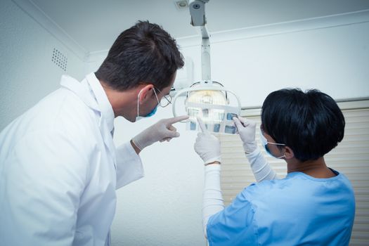 Concentrated two dentists looking at x-ray