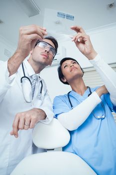 Concentrated two dentists looking at x-ray