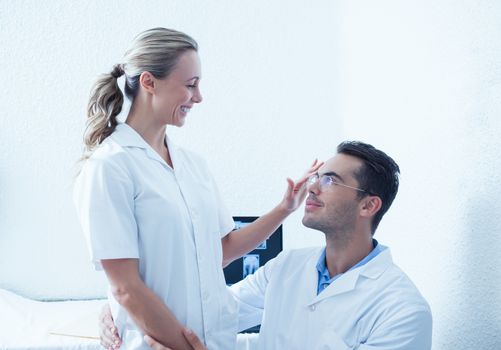 Young male and female dentists looking at each other