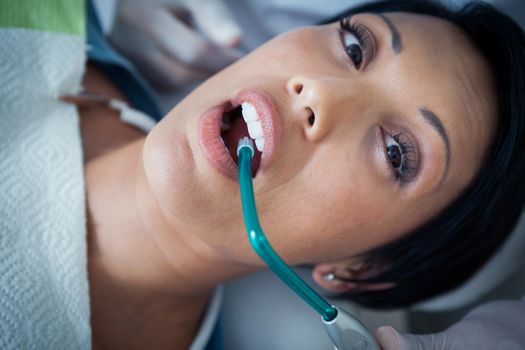 Close up of woman having her teeth examined by dentist
