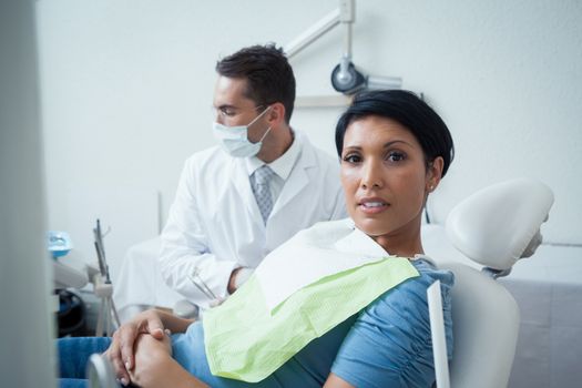 Portrait of serious young woman waiting for a dental exam