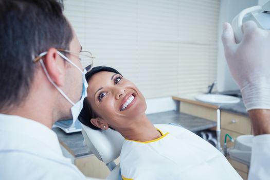 Side view of smiling young woman waiting for a dental exam