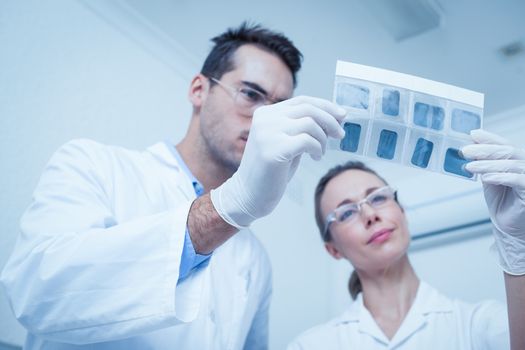 Concentrated two dentists looking at x-ray