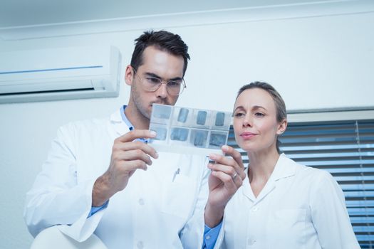 Two concentrated dentists looking at x-ray