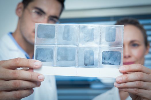 Two concentrated dentists looking at x-ray