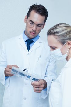 Two concentrated dentists looking at x-ray