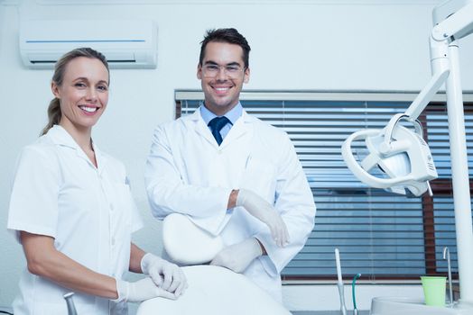 Portrait of smiling male and female dentists