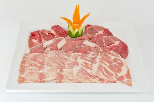 Assorted Fresh Cured Meats on white dish isolate