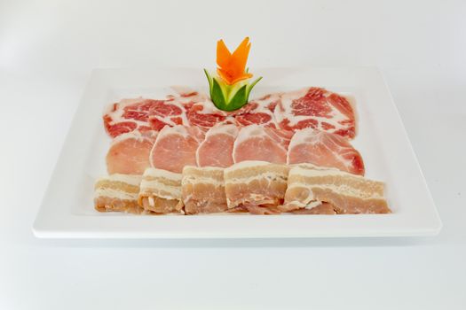 Assorted Fresh Cured Meats on white dish isolate