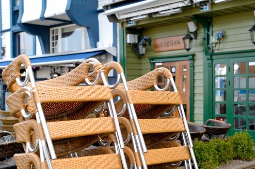 Stack of Chairs Outside a Quayside Resaurant Bar on the Waterfront in Skagenkaien Stavanger Norway
