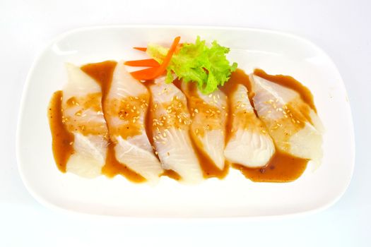 Fresh Dolly fish slice on white dish isolate on white background ready to be grilled.