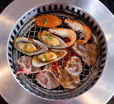 Mixed Roasted Meat and Seafood on the BBQ Grill on roast.