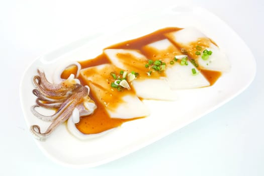 Raw squid slice on white dish isolate on white background ready to be grilled