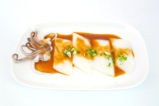 Raw squid slice on white dish isolate on white background ready to be grilled