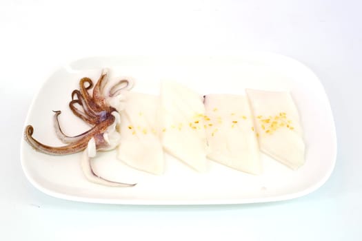 Raw squid slice on white dish isolate on white background ready to be grilled