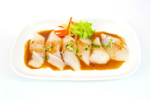 Fresh Dolly fish slice on white dish isolate on white background ready to be grilled.