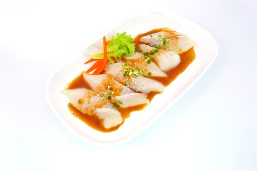 Fresh Dolly fish slice on white dish isolate on white background ready to be grilled.