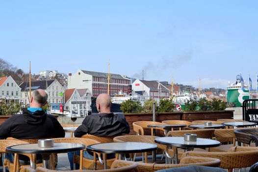 Two People Relaxing Outside the Dickens Pub in Skagenkaien Overlooking Stavanger Harbour