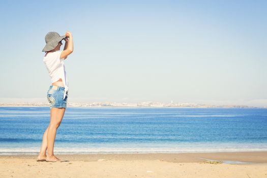 Beautiful young woman enjoying the beach 