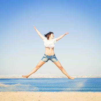 Beautiful young woman enjoying the beach 